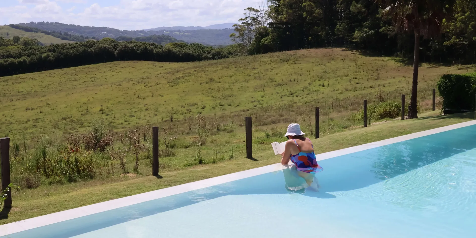 Mum relaxing at a pool at a beautiful minds australia® mother and daughter retreat.