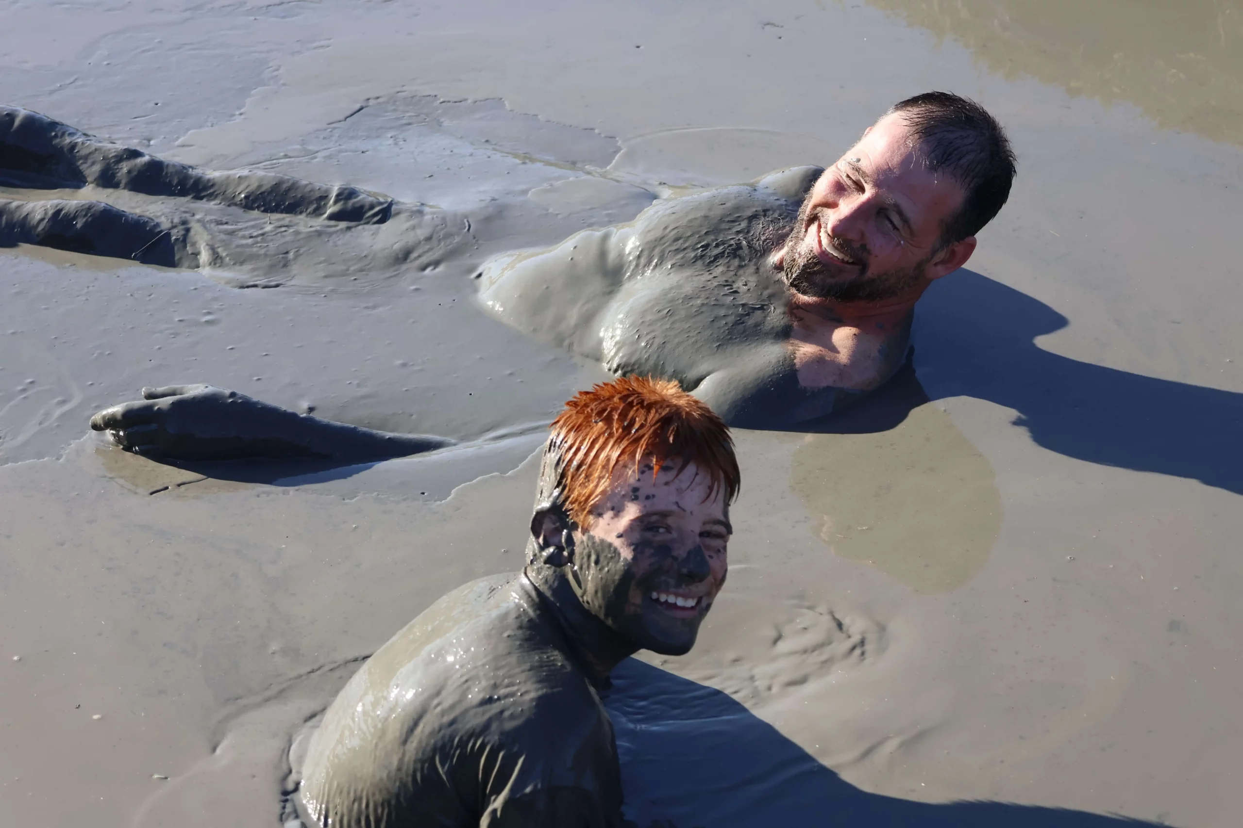 Dad and son in thick mud